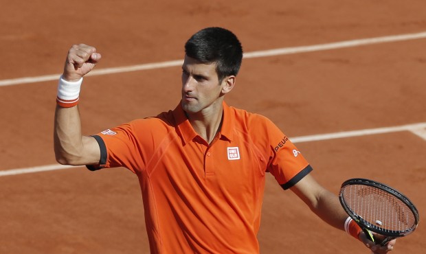 Serbia’s Novak Djokovic celebrates winning the quarterfinal match of the French Open tennis t...