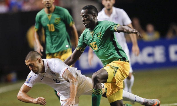 United States’ Clint Dempsey (8) and Jamaica’s Je-Vaughn Watson (15) vie for at the bal...