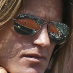 
              Suzanne Lenglen court is reflected in the sunglasses of Amelie Mauresmo of France who coaches Britain's Andy Murray in the third round match of the French Open tennis tournament against Australia's Nick Kyrgios at the Roland Garros stadium, in Paris, France, Saturday, May 30, 2015. (AP Photo/David Vincent)
            