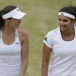 
              Martina Hingis from Switzerland, left, and Sania Mirza from India talk between points during their doubles match against Casey Dellacqua from Australia and Yaroslava Shvedova from Kazakhstan at the All England Lawn Tennis Championships in Wimbledon, London, Wednesday July 8, 2015. (AP Photo/Tim Ireland)
            