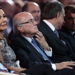 
              FIFA President Sepp Blatter, center, and his partner Linda Barras, left, attend the preliminary draw for the 2018 soccer World Cup in Konstantin Palace in St. Petersburg, Russia, Saturday, July 25, 2015. (AP Photo/Ivan Sekretarev)
            