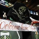 
              Portland Thorns fans wave flags during the second half of the team's NWSL soccer match against the Seattle Reign in Portland, Ore., Wednesday, July 22, 2015. Seattle won 1-0. (AP Photo/Don Ryan)
            
