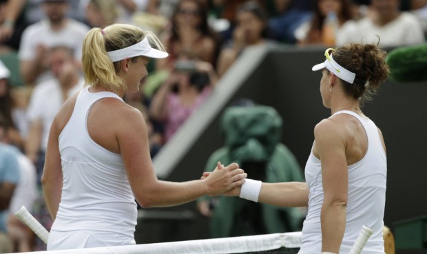 Coco Vandeweghe of the United States, left, shakes hands at the net with Samantha Stosur of Austral...