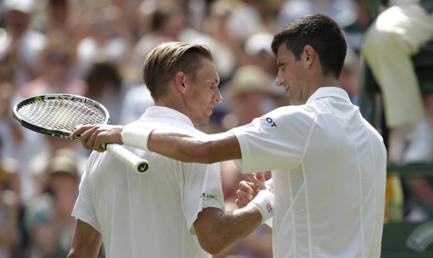 Novak Djokovic of Serbia, right embraces Jarkko Nieminen of Finland after their singles match at th...