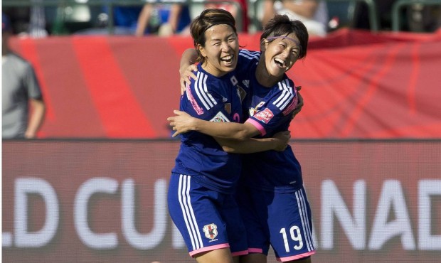 Japan’s Azusa Iwashimizu and Saori Ariyoshi (19) celebrate the team’s 2-1 win as Englan...