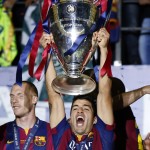 
              Barcelona's Luis Suarez celebrates with the trophy after the Champions League final soccer match between Juventus Turin and FC Barcelona at the Olympic stadium in Berlin Saturday, June 6, 2015. Barcelona won the match 3-1. (AP Photo/Luca Bruno)
            