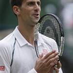
              Novak Djokovic of Serbia celebrates winning a point against Roger Federer of Switzerland during the men's singles final at the All England Lawn Tennis Championships in Wimbledon, London, Sunday July 12, 2015. (AP Photo/Pavel Golovkin)
            