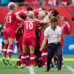 
              Canada coach John Herdman, right, celebrates as Josee Belanger, back, is mobbed by her teammates after scoring against Switzerland during the second half of the FIFA Women's World Cup round of 16 soccer action in Vancouver, British Columbia, Canada on Sunday June 21, 2015. (Darryl Dyck/The Canadian Press via AP)
            
