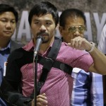 
              Filipino boxer and Congressman Manny Pacquiao answers questions from the media during a news conference upon arrival Wednesday, May 13, 2015 at the Ninoy Aquino International Airport at suburban Pasay city south of Manila, Philippines. Pacquiao, who was defeated by Floyd Mayweather Jr. in their welterweight fight in Las Vegas May 2, faces lawsuits allegedly for not disclosing his shoulder injury before the fight. (AP Photo/Bullit Marquez)
            