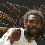 
              Dustin Brown of Germany serves to Viktor Troicki of Serbia during their singles tennis match at the All England Lawn Tennis Championships in Wimbledon, London, Saturday July 4, 2015. (AP Photo/Pavel Golovkin)
            