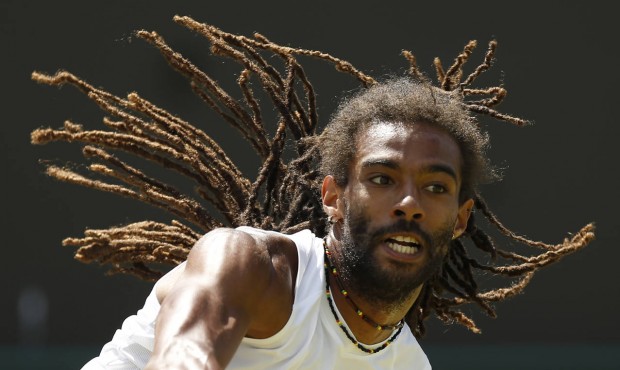 Dustin Brown of Germany serves to Viktor Troicki of Serbia during their singles tennis match at the...