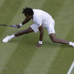 
              Gael Monfis of France slips during the singles match against  Gilles Simon of France at the All England Lawn Tennis Championships in Wimbledon, London, Saturday July 4, 2015. (AP Photo/Pavel Golovkin)
            