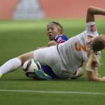
              Japan's Yuki Ogimi, back, and Netherlands' Stefanie van der Gragt collide during the first half of a round of 16 soccer match at the FIFA Women's World Cup, Tuesday, June 23, 2015, in Vancouver, British Columbia, Canada. (Darryl Dyck/The Canadian Press via AP)
            