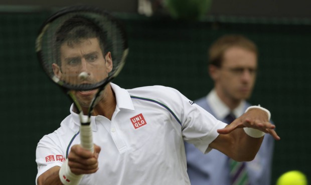 Novak Djokovic of Serbia returns a ball to Kevin Anderson of South Africa during their singles matc...