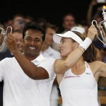 
              Leander Paes of India, left, and Martina Hingis of Switzerland hold up the trophies after winning the mixed doubles final against Alexander Peya of Austria and Timea Babos of Hungary at the All England Lawn Tennis Championships in Wimbledon, London, Sunday July 12, 2015.  (AP Photo/Alastair Grant)
            