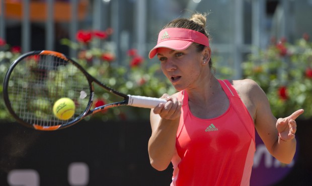 Simona Halep, of Romania, returns the ball to Alison Riske, of the United States, during their matc...