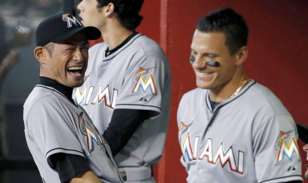 Miami Marlins’ Ichiro Suzuki, left, of Japan, laughs along with teammate Derek Dietrich prior...