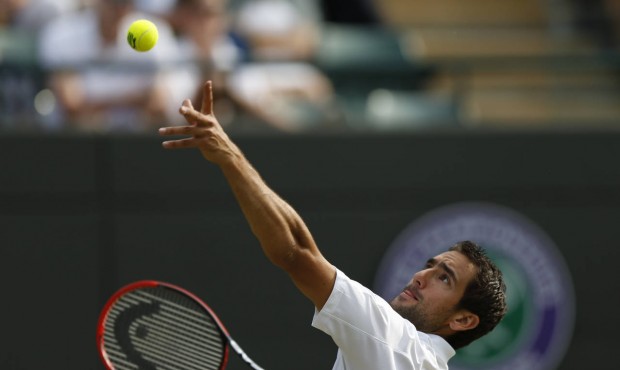 Marin Cilic of Croatia serves to John Isner of the United States during their singles match at the ...