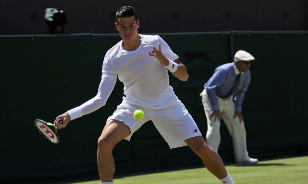 Milos Raonic of Canada returns a ball to Nick Kyrgios of Australia during their singles match at th...