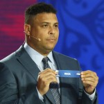
              Brazilian soccer legend Ronaldo holds the lot of Brazil during the preliminary draw for the 2018 soccer World Cup in Konstantin Palace in St. Petersburg, Russia, Saturday, July 25, 2015. (AP Photo/Dmitry Lovetsky
            