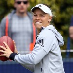 
              Denmark's Caroline Wozniacki warms up with an American football on the practice courts ahead of her semifinal match against Switzerland's Belinda Bencic during day seven of the international women's tournament at Eastbourne, England, Friday June 26, 2015. (Gareth Fuller/PA via AP) UNITED KINGDOM OUT  NO SALES  NO ARCHIVE
            