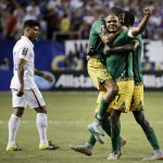 
              Jamaica’s Rudolph Austin, facing camera, celebrates with teammates Joel McAnuff, left, and Je-Vaughn Watson, right, as United States’ DeAndre Yedlin walks off the pitch after Jamaica defeated the United States 2-1 in a CONCACAF Gold Cup soccer semifinal Wednesday, July 22, 2015, in Atlanta. (AP Photo/David Goldman)
            