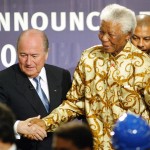 
              FILE - In this May 15, 2004 file photo, former South African President Nelson Mandela is assisted by FIFA president Sepp Blatter, left, in Zurich, Switzerland, where it was announced that South Africa would host the 2010 FIFA World Cup soccer tournament. The country's image has been shattered with allegations that its bid over a decade ago was involved in millions of dollars in bribes to secure FIFA votes and make sure of its historic place as Africa's first World Cup host. (AP Photo/Michael Probst, File)
            