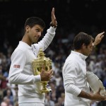
              Novak Djokovic of Serbia, left, and Roger Federer of Switzerland hold their trophies after Djokovic won the men's singles final at the All England Lawn Tennis Championships in Wimbledon, London, Sunday July 12, 2015. Djokovic won the match 7-6, 6-7, 6-4, 6-3. (Toby Melville/Pool Photo via AP)
            