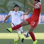 
              United States' Ali Krieger (11) and China's Liu Shanshan (2) battle for the ball during the first half of a quarterfinal match in the FIFA Women's World Cup soccer tournament, Friday, June 26, 2015, in Ottawa, Ontario, Canada. (Adrian Wyld/The Canadian Press via AP)
            