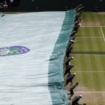 
              Ball boys cover Centre Court as rain starts to fall during the men's singles quarterfinal match between Andy Murray of Britain and Vasek Pospisil of Canada at the All England Lawn Tennis Championships in Wimbledon, London, Wednesday July 8, 2015. (AP Photo/Alastair Grant)
            