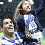 
              Barcelona's Luis Suarez celebrates with one of his daughters after his team won 3-1 the Champions League final soccer match between Juventus Turin and FC Barcelona at the Olympic stadium in Berlin Saturday, June 6, 2015. (AP Photo/Michael Probst)
            