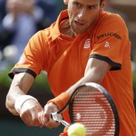 
              Serbia's Novak Djokovic returns the ball to Luxembourg's Gilles Muller during their second round match of the French Open tennis tournament at the Roland Garros stadium, Thursday May 28, 2015 in Paris. (AP Photo/Thibault Camus)
            