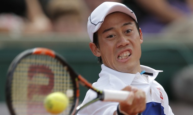 Japan’s Kei Nishikori returns the ball to France’s Paul-Henri Mathieu during their firs...