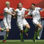 
              From left, United States' Megan Rapinoe, Lauren Holiday, and Carli Lloyd celebrate after Lloyd scored her second goal of the match against Japan during the first half of the FIFA Women's World Cup soccer championship in Vancouver, British Columbia, Canada, Sunday, July 5, 2015. (AP Photo/Elaine Thompson)
            