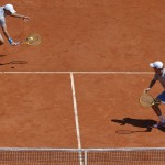 
              Bob, right, and Mike Bryan of the U.S. return in the men's double semifinal match of the French Open tennis tournament against Italy's Simone Bolelli and Fabio Fognini at the Roland Garros stadium, in Paris, France, Thursday, June 4, 2015. (AP Photo/Christophe Ena)
            