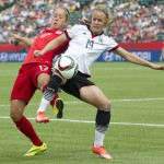 
              England's Josanne Potter (17) vies for the ball with Germany's Lena Petermann (19) during first-half action in a FIFA Women's World Cup consolation final soccer game in Edmonton, Alberta, Canada, on Saturday, July 4, 2015. (Jason Franson/The Canadian Press via AP) MANDATORY CREDIT
            