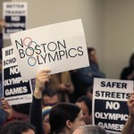 
              FILE - In this Feb. 5, 2015, file photo, people in the audience hold up placards against the Olympic Games coming to Boston, during the first public forum regarding the city's 2024 Olympic bid, in Boston. While Bostonians are hesitant to host the Olympics, Americans across the country overwhelmingly support the idea of the games on home turf, according to a new Associated Press-GfK poll. The support decreases when people are asked if they would want the Olympics in their local area. It dips even further when they are asked if public funds should be used to pay for them. (AP Photo/Charles Krupa, File)
            