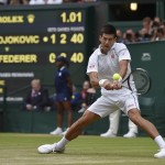 
              Novak Djokovic of Serbia plays a return to Roger Federer of Switzerland during the men's singles final at the All England Lawn Tennis Championships in Wimbledon, London, Sunday July 12, 2015. (Toby Melville/Pool Photo via AP)
            