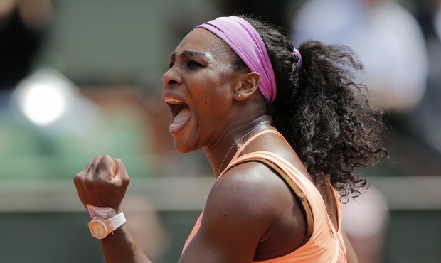 Serena Williams of the U.S. clenches her fist after scoring a point in the quarterfinal match of th...