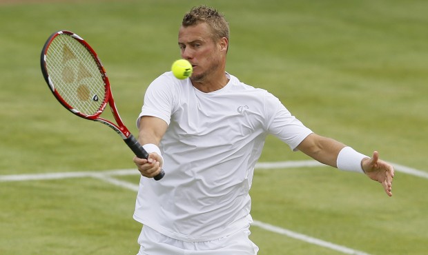 Lleyton Hewitt of Australia plays a return to Kevin Anderson of South Africa during their singles t...