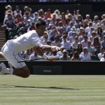 
              Novak Djokovic of Serbia drops his racquet after making a return to Richard Gasquet of France, during their men's singles semifinal match at the All England Lawn Tennis Championships in Wimbledon, London, Friday July 10, 2015. (AP Photo/Pavel Golovkin)
            