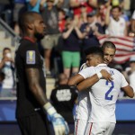 
              United States' Clint Dempsey, right, and DeAndre Yedlin celebrate after Dempsey's goal against Panama goalkeeper Luis Mejia, left, during the second half of the CONCACAF Gold Cup third place soccer match, Saturday, July 25, 2015, in Chester, Pa. (AP Photo/Michael Perez)
            
