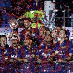 
              Barcelona players celebrate with the trophy after the Champions League final soccer match between Juventus Turin and FC Barcelona at the Olympic stadium in Berlin Saturday, June 6, 2015. Barcelona won the match 3-1.  (AP Photo/Frank Augstein)
            
