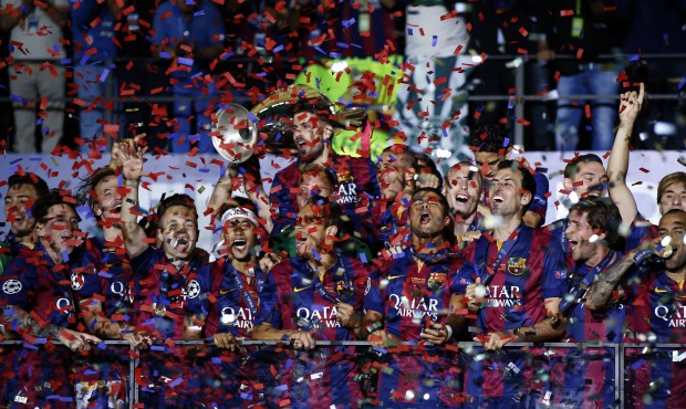 Barcelona players celebrate with the trophy after the Champions League final soccer match between J...