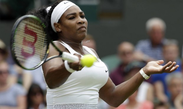 Serena Williams of the United States returns a ball to Venus Williams of the United States, during ...