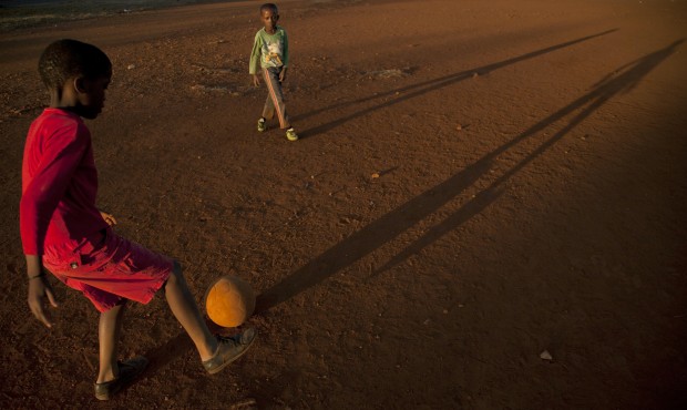 Young boys play soccer on a dusty field in Thokoza township east of Johannesburg, South Africa, Thu...