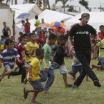 
              FILE - In this Friday, Feb. 14, 2014 file photo, David Beckham plays soccer with young typhoon-survivors during his visit to typhoon-ravaged Tanauan township, Leyte province in central Philippines.   Beckham turns 40 on Saturday May 2, but since retiring, England’s former captain continues to prosper off the field, where his multi-faceted life centers on celebrity and fashion, but also ambassadorial roles and an ambitious project to create a Miami team in the increasingly popular Major League Soccer.  (AP Photo/Bullit Marquez, file)
            