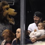 
              FILE - In this Saturday, April 12, 2014 file photo, David Beckham sits with his daughter, Harper, as Los Angeles Kings mascot Bailey visits while they watch the Kings play the Anaheim Ducks during the first period of an NHL hockey game, in Los Angeles.  Beckham turns 40 on Saturday May 2, but since retiring, England’s former captain continues to prosper off the field, where his multi-faceted life centers on celebrity and fashion, but also ambassadorial roles and an ambitious project to create a Miami team in the increasingly popular Major League Soccer.   (AP Photo/Mark J. Terrill, file)
            