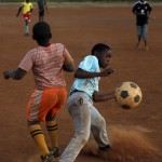
              Young boys play soccer on a dusty field in Thokoza township east of Johannesburg, South Africa, Thursday, May 28, 2015.  The image of South Africa’s 2010 World Cup has been shattered by allegations that its bid over a decade ago was involved in bribes of more than $10 million to secure FIFA votes _ possibly with the knowledge or involvement of the South African government.  (AP Photo/Themba Hadebe)
            