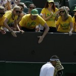 
              Australian fans cheer on Nick Kyrgios of Australia during the singles match against Milos Raonic of Canada, at the All England Lawn Tennis Championships in Wimbledon, London, Friday July 3, 2015. (AP Photo/Tim Ireland)
            